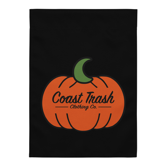 Front view of Coast Trash Halloween garden flag with orange pumpkin and green crescent on black